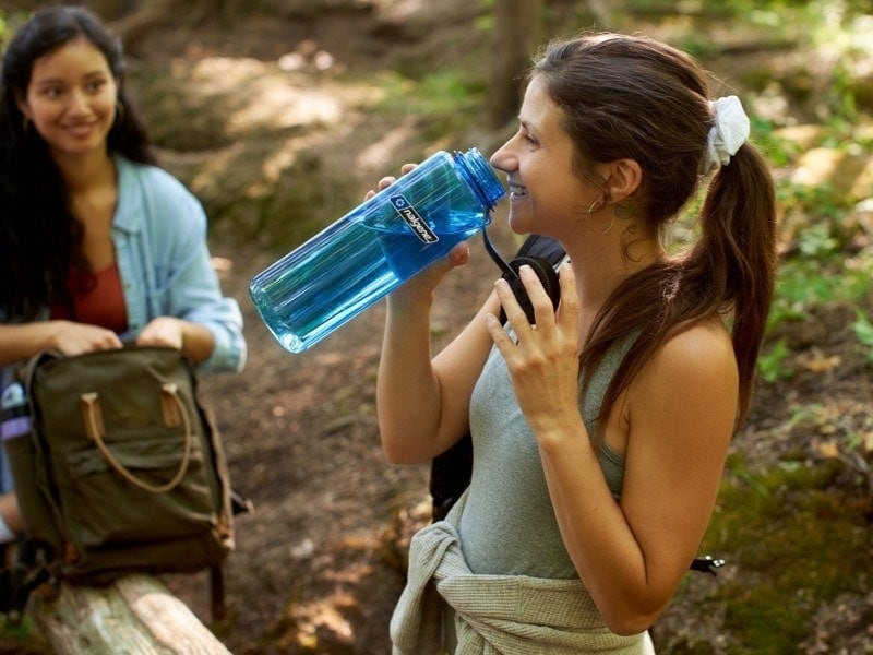 woman drinking from 48oz silo water bottle